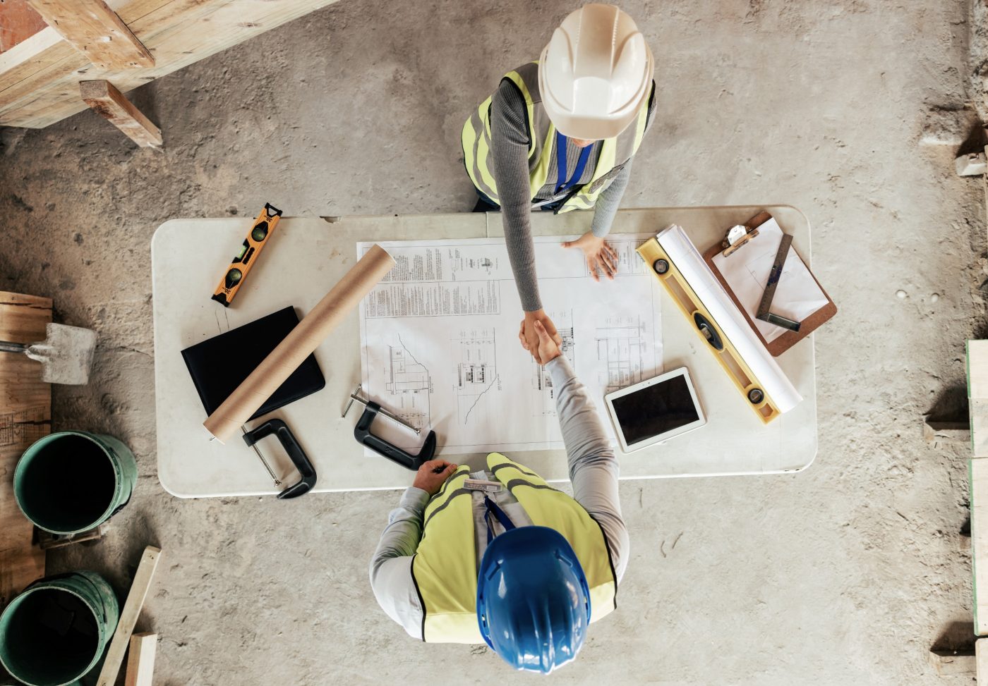 Architect, handshake and thank you for construction, blueprint and collaboration on building design.